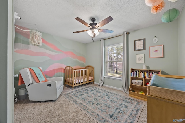 170 Jarrett Ln, Madison, AL 35758 - bedroom with carpet flooring, a crib, a textured ceiling, and a ceiling fan
