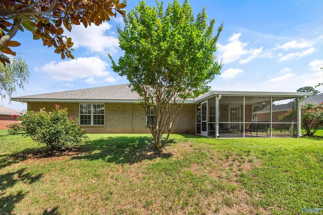 170 Jarrett Ln, Madison, AL 35758 - rear view of house with a sunroom, a yard, and brick siding