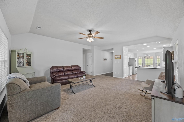 170 Jarrett Ln, Madison, AL 35758 - living area with vaulted ceiling, light carpet, a chandelier, a ceiling fan, and a textured ceiling