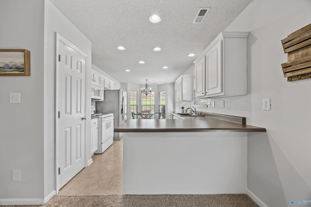 170 Jarrett Ln, Madison, AL 35758 - kitchen featuring white appliances, a chandelier, recessed lighting, a peninsula, and white cabinets