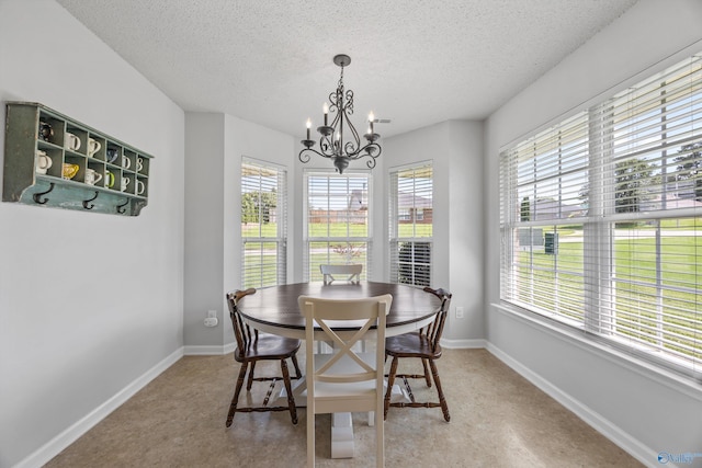 170 Jarrett Ln, Madison, AL 35758 - dining room with plenty of natural light, a textured ceiling, and a chandelier
