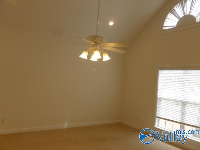 carpeted spare room with a ceiling fan, high vaulted ceiling, baseboards, and recessed lighting