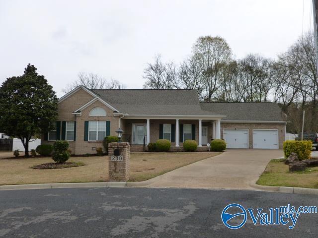ranch-style house with a garage and concrete driveway