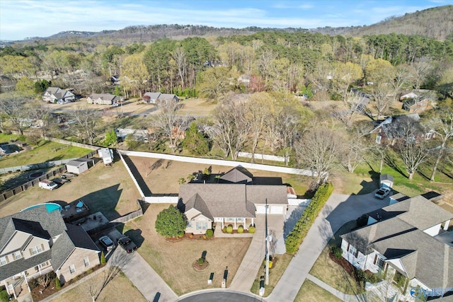 birds eye view of property with a view of trees
