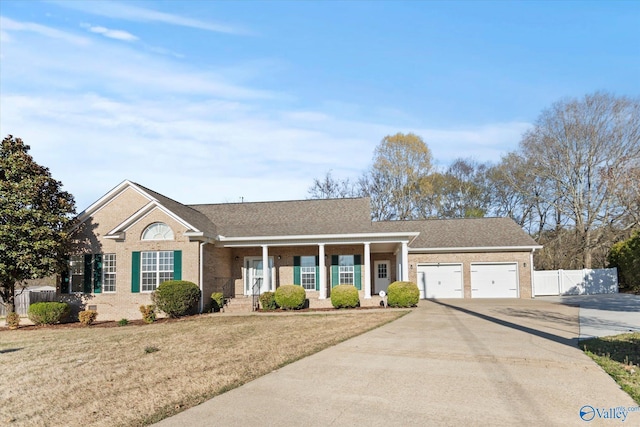 ranch-style house with a front lawn, driveway, an attached garage, and fence