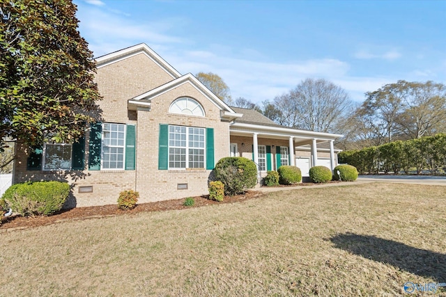view of front facade with brick siding, a front yard, and crawl space