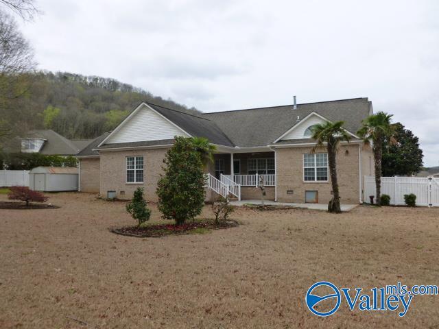 ranch-style home with a storage shed, covered porch, fence, and an outbuilding