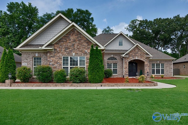 craftsman inspired home with a front lawn