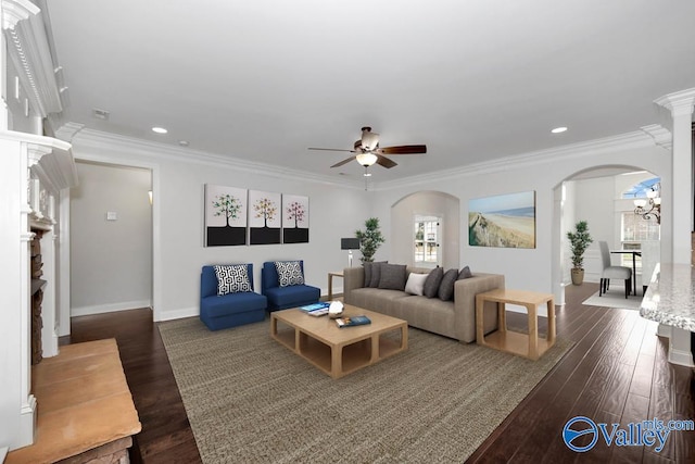 living room featuring decorative columns, crown molding, dark hardwood / wood-style floors, and ceiling fan