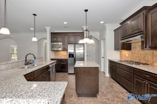 kitchen featuring appliances with stainless steel finishes, tasteful backsplash, sink, decorative light fixtures, and light tile patterned floors