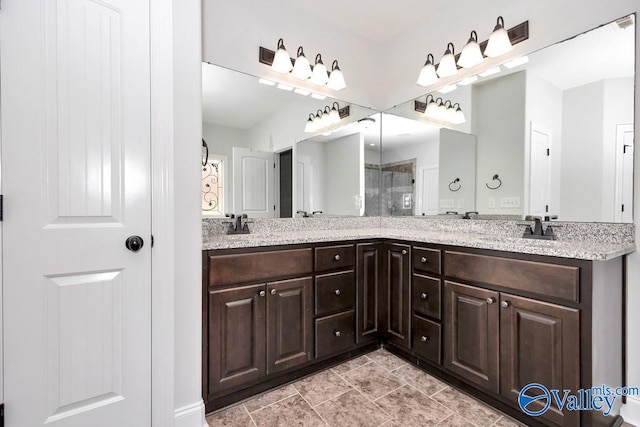 bathroom with double vanity and tile patterned floors