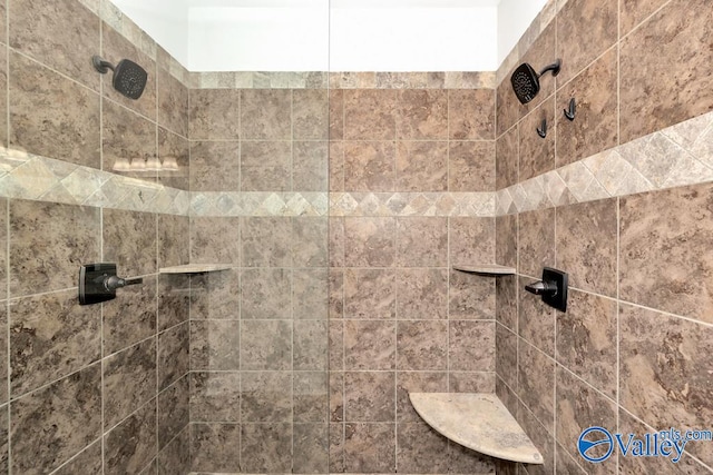 interior details featuring a tile shower