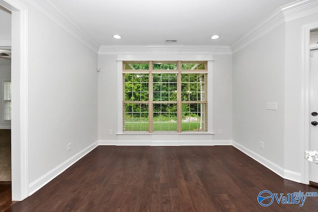 spare room featuring hardwood / wood-style flooring and ornamental molding