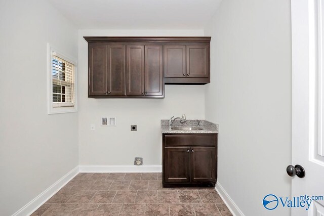 clothes washing area featuring light tile patterned flooring, hookup for an electric dryer, cabinets, washer hookup, and sink