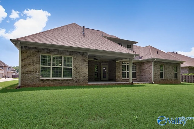 rear view of property featuring a patio area, a yard, and ceiling fan