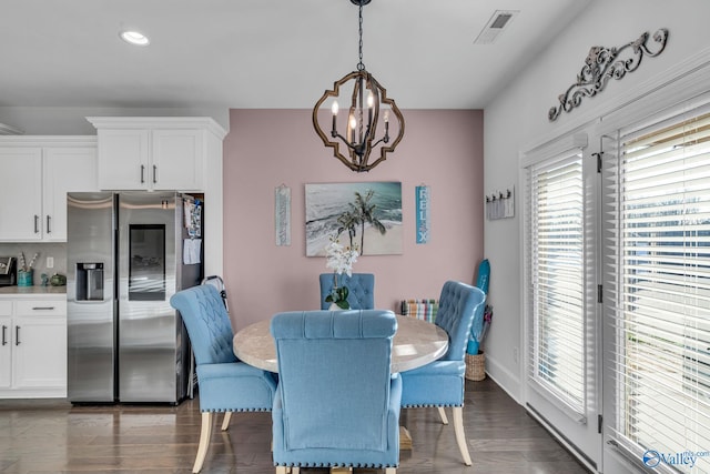 dining space with recessed lighting, a notable chandelier, wood finished floors, visible vents, and baseboards