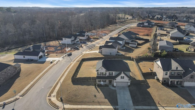 aerial view featuring a residential view and a wooded view