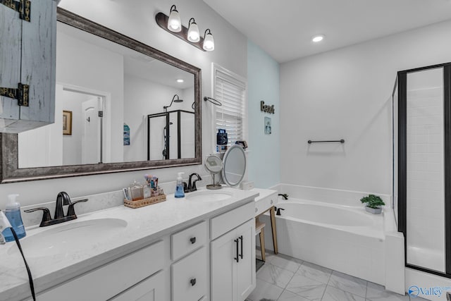 bathroom with a garden tub, double vanity, a stall shower, and a sink