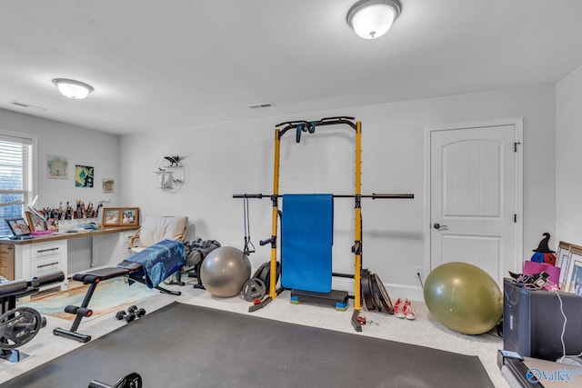 workout area featuring visible vents and baseboard heating