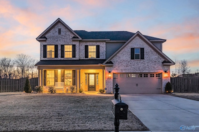 traditional home with brick siding, concrete driveway, covered porch, fence, and a garage