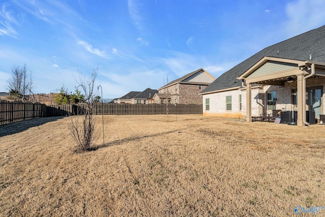 view of yard with a patio area and a fenced backyard