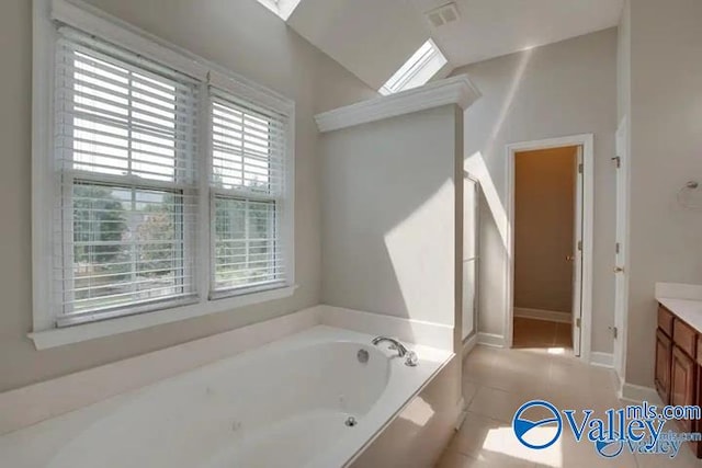 bathroom featuring vanity, tile patterned flooring, and a bathing tub