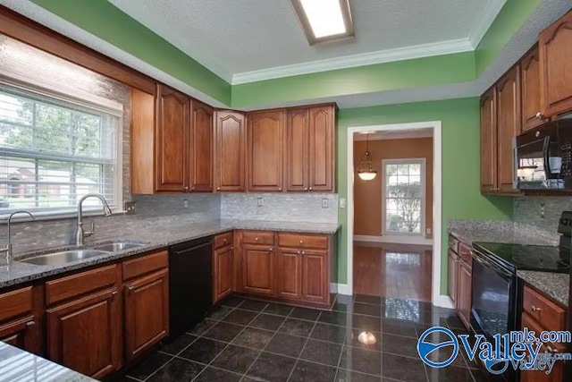 kitchen with black appliances, a healthy amount of sunlight, decorative backsplash, and sink