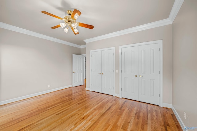 904 Driver Rd NW, Fort Payne, AL 35967 - unfurnished bedroom with light wood-type flooring, baseboards, two closets, and ornamental molding