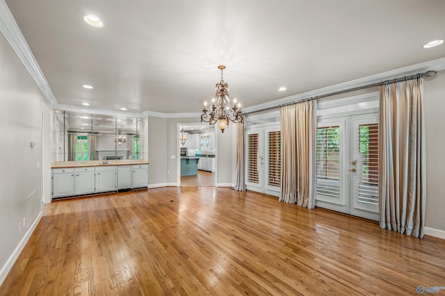 904 Driver Rd NW, Fort Payne, AL 35967 - unfurnished living room featuring light wood finished floors, recessed lighting, ornamental molding, french doors, and a notable chandelier