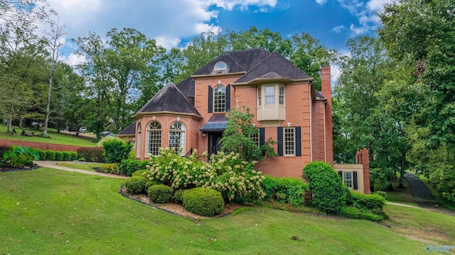 904 Driver Rd NW, Fort Payne, AL 35967 - view of front facade featuring a front yard, brick siding, and a chimney