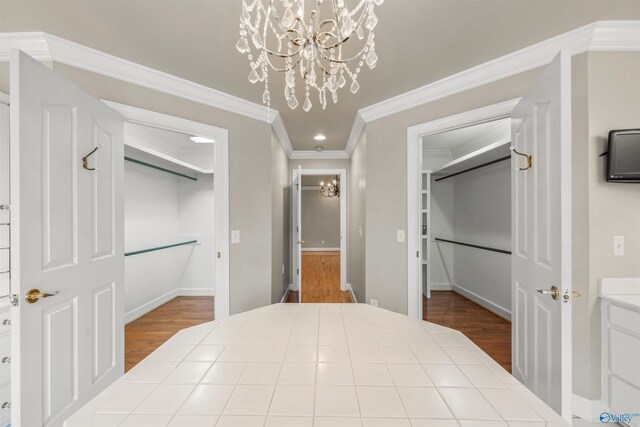 interior space featuring crown molding, hardwood / wood-style flooring, and a chandelier