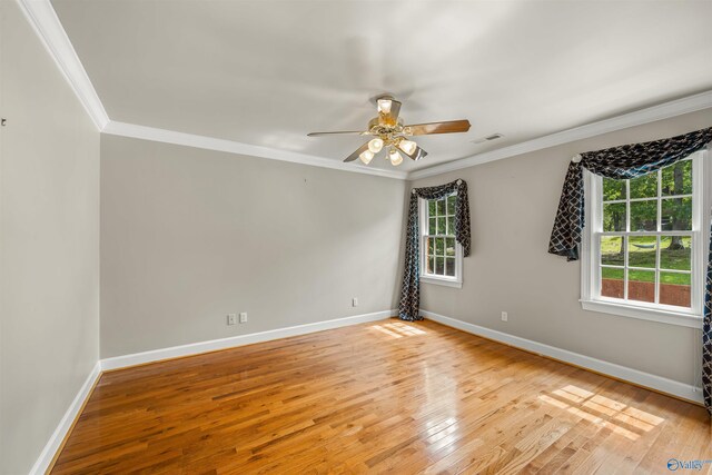 empty room featuring ceiling fan, ornamental molding, and light hardwood / wood-style floors