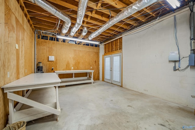 basement featuring wood walls