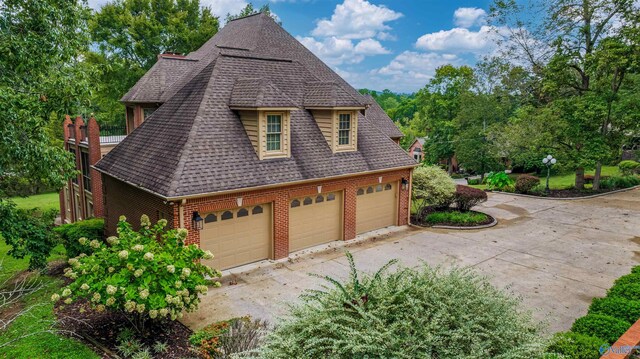 904 Driver Rd NW, Fort Payne, AL 35967 - view of side of property featuring brick siding, a garage, concrete driveway, and roof with shingles