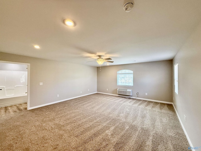 unfurnished room featuring ceiling fan, carpet flooring, and a wall unit AC