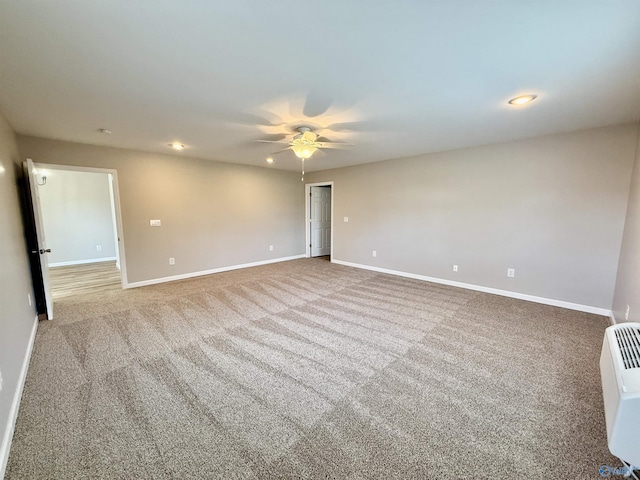 spare room with carpet floors and ceiling fan