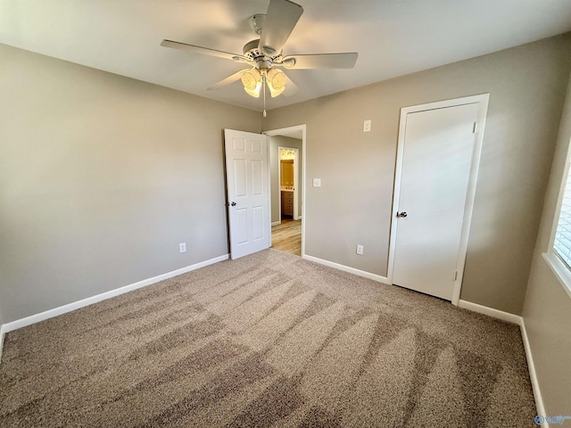 unfurnished bedroom with ceiling fan and light colored carpet