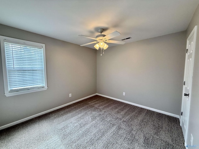 carpeted spare room featuring ceiling fan