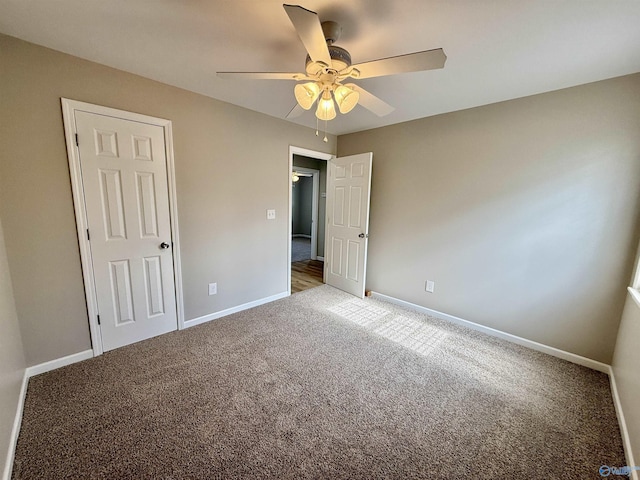 unfurnished bedroom with ceiling fan and carpet