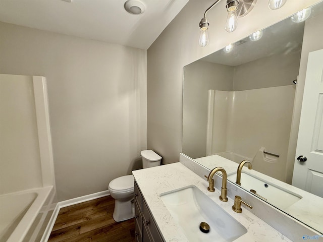 bathroom featuring vanity, wood-type flooring, and toilet