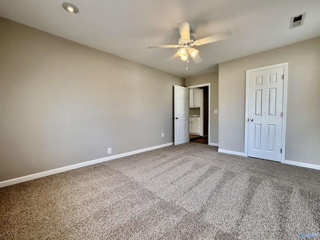 unfurnished bedroom featuring carpet floors and ceiling fan