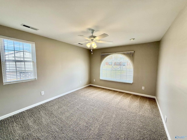 carpeted empty room featuring ceiling fan