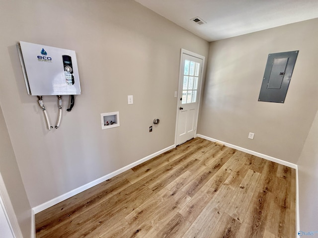 doorway to outside with wood-type flooring and electric panel