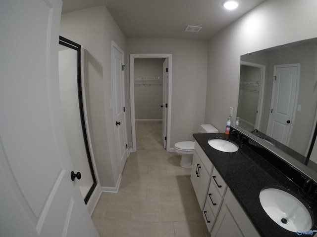 bathroom featuring tile patterned flooring, vanity, and toilet