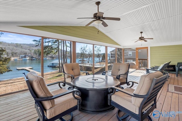 wooden terrace featuring a water view and ceiling fan