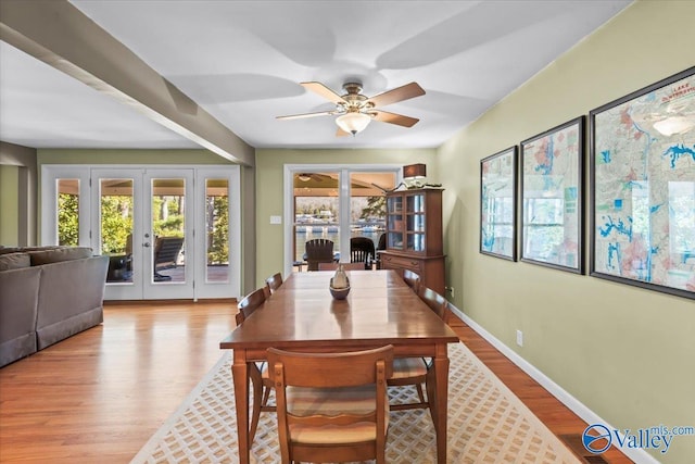 dining area featuring ceiling fan, french doors, and light wood-type flooring