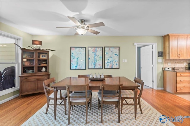 dining room with ceiling fan and light hardwood / wood-style floors