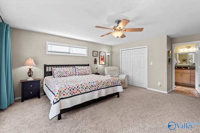 bedroom featuring ceiling fan, connected bathroom, a closet, and light carpet