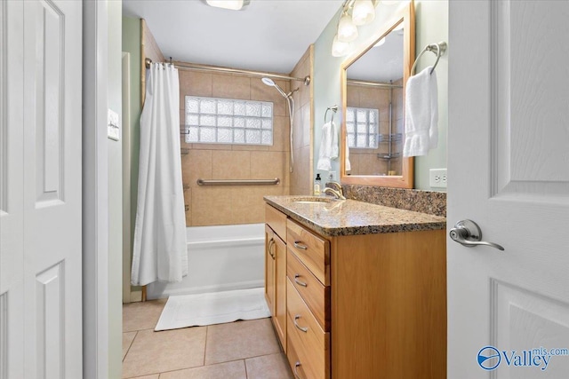 bathroom featuring tile patterned flooring, shower / tub combo, and vanity