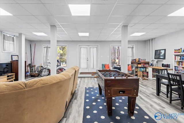 playroom featuring a drop ceiling and light hardwood / wood-style flooring